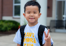  a boy giving the peace sign
